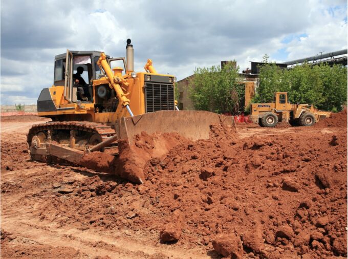 Large bulldozer pushing around dirt.